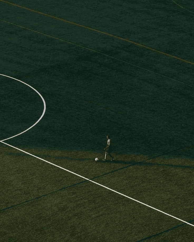 Soccer player training alone on a field