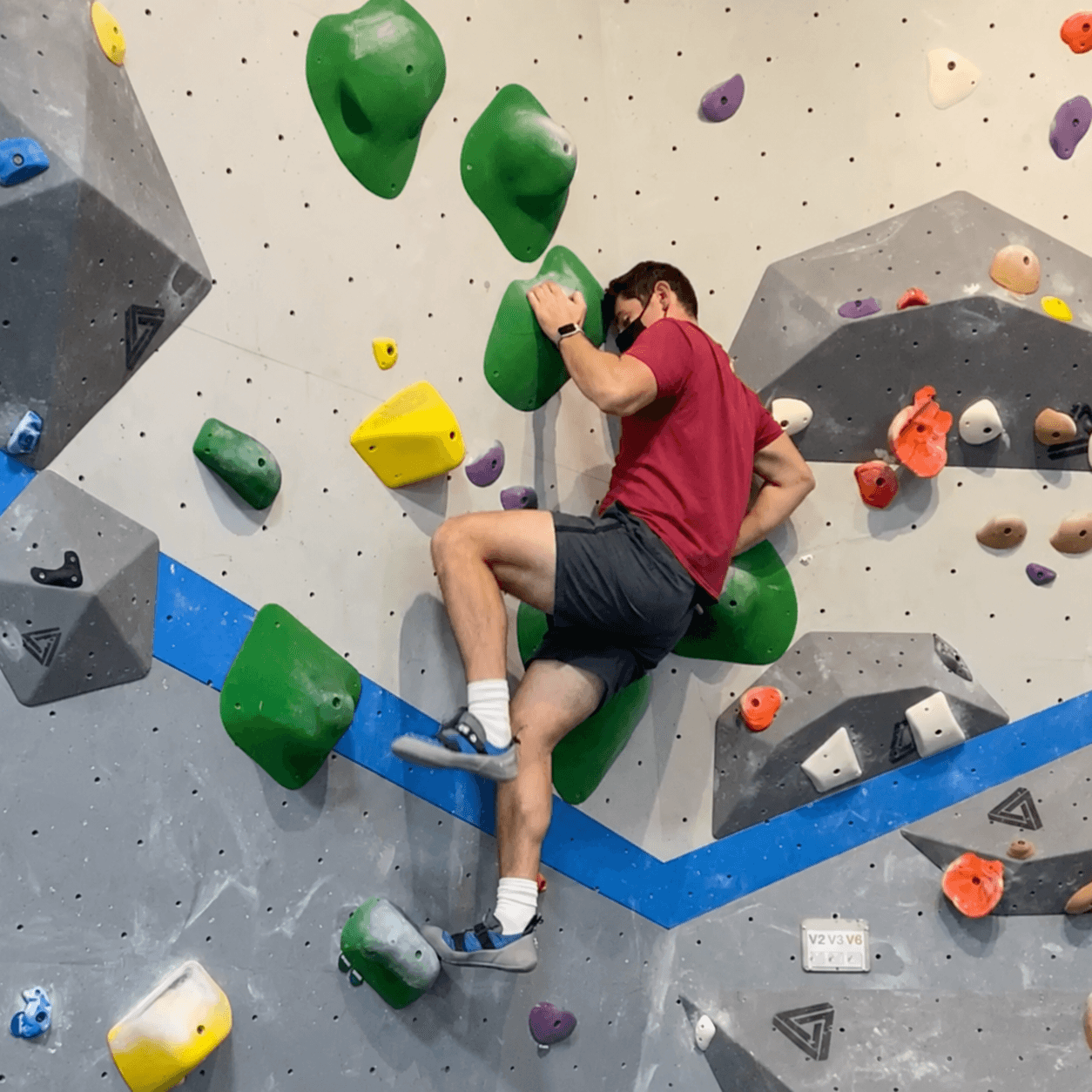 GoodMetal member climbing an indoor bouldering wall